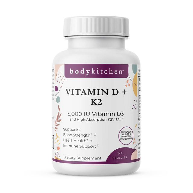 A bottle of Body Kitchen Vitamin D + K2 supplement with 60 capsules, featuring 5000 IU of Vitamin D3 and 180 mcg of K2. The label highlights bone strength, heart health, and immune support.