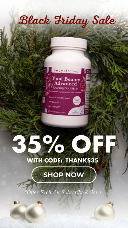 Body Kitchen Total Beauty Advanced supplement bottle with Christmas decorations and Black Friday sale text.